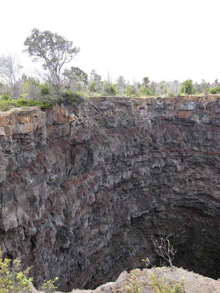 Devil's Throat crater, Hawaii Volcanoes National Park. The walls used to be extremely undercut, with only a small opening at the top, but it has gradually collapsed so that the walls are now almost vertical. Devils Throat 1655.jpg